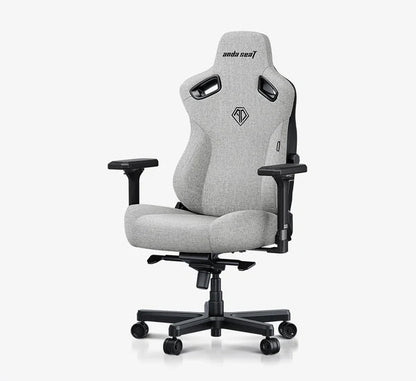 A light gray fabric gaming chair with black armrests, base, and side supports, shown on a white background with a black banner at the bottom reading 'Best Budget Big and Tall Gaming Chair by IGN'.