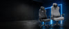 Black PVC leather and grey linen AndaSeat Novis gaming chairs in a dark blue studio