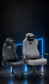 Black PVC leather and grey linen AndaSeat Novis gaming chairs in a dark blue studio