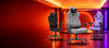 AndaSeat Novis Max XL Grey Fabric, X-Air Pro Space Black and Kaiser 4 Purple gaming chairs on a bright orange September Savings stage.
