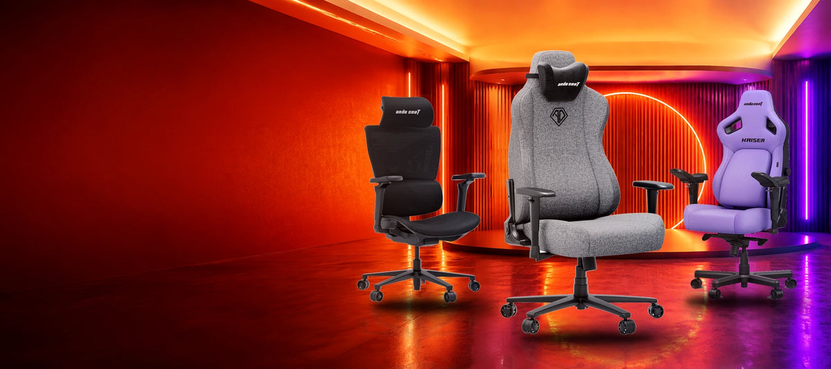 AndaSeat Novis Max XL Grey Fabric, X-Air Pro Space Black and Kaiser 4 Purple gaming chairs on a bright orange September Savings stage.