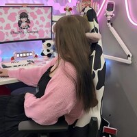 Raquel “DeathlyKawaii” Long at a pink gaming setup with an AndaSeat chair