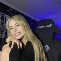 Hannah Sayce beside an AndaSeat gaming chair